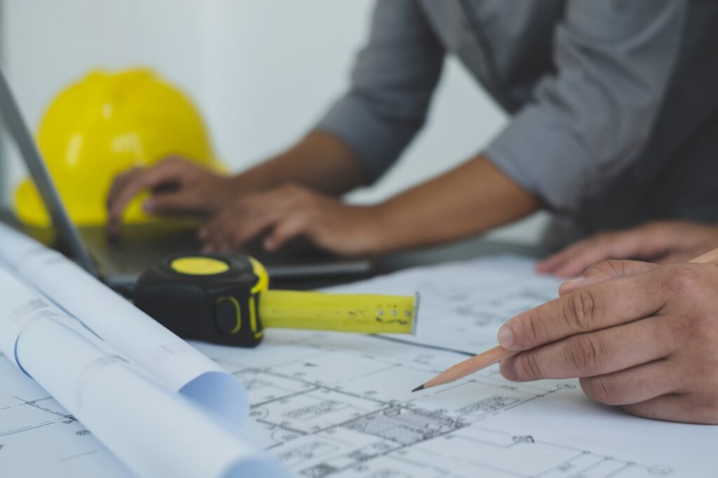 Team of engineers and architects, working team, meeting, discussing construction and drawing constru